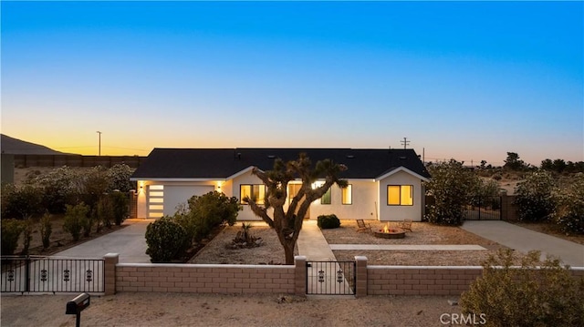 62290 Crestview Dr, Joshua Tree, CA 92252 - view of front of home featuring an outdoor fire pit, concrete driveway, a gate, and a fenced front yard