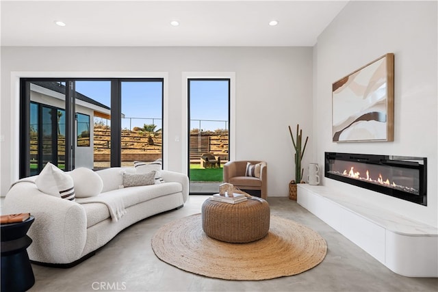 62290 Crestview Dr, Joshua Tree, CA 92252 - living area featuring concrete flooring, a glass covered fireplace, and recessed lighting