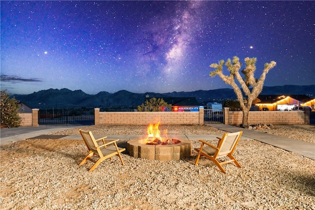 62290 Crestview Dr, Joshua Tree, CA 92252 - view of patio featuring an outdoor fire pit and a mountain view