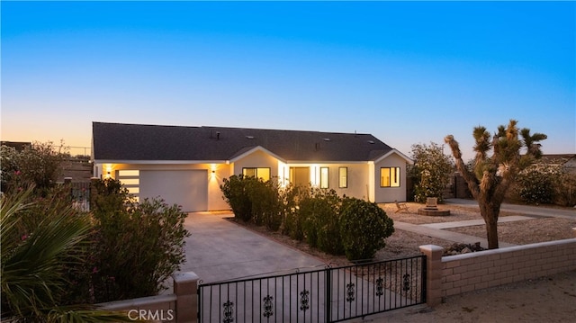 62290 Crestview Dr, Joshua Tree, CA 92252 - view of front of property featuring concrete driveway, stucco siding, a fenced front yard, and a garage