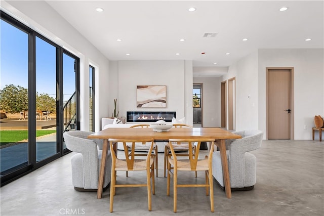 62290 Crestview Dr, Joshua Tree, CA 92252 - dining area with concrete floors, recessed lighting, and a glass covered fireplace