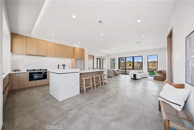 62290 Crestview Dr, Joshua Tree, CA 92252 - kitchen featuring modern cabinets, finished concrete floors, oven, backsplash, and recessed lighting