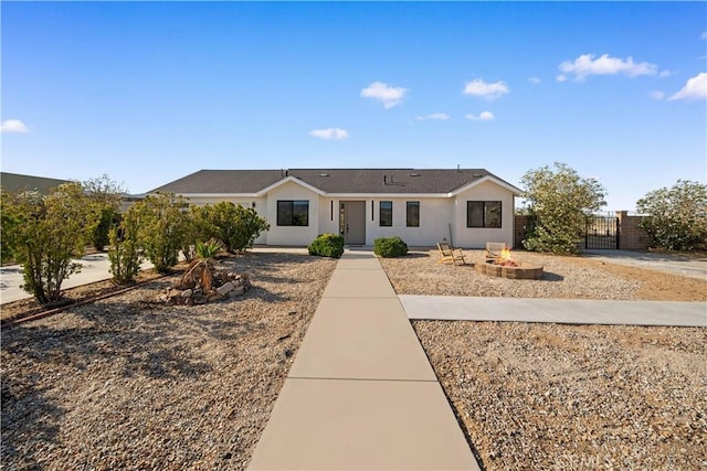 62290 Crestview Dr, Joshua Tree, CA 92252 - ranch-style home featuring a fire pit, a gate, and stucco siding