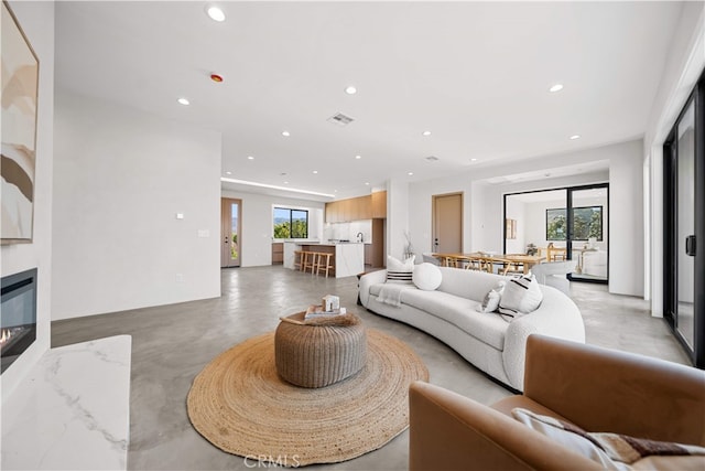 62290 Crestview Dr, Joshua Tree, CA 92252 - living room with plenty of natural light, finished concrete floors, recessed lighting, and a high end fireplace