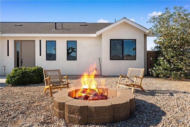 62290 Crestview Dr, Joshua Tree, CA 92252 - rear view of property with a fire pit, roof with shingles, and stucco siding