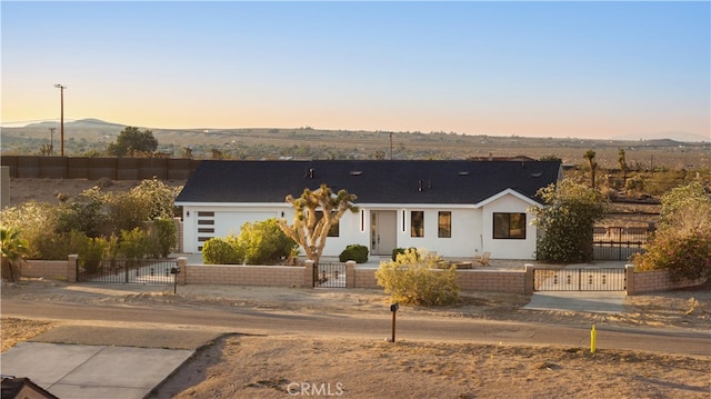 62290 Crestview Dr, Joshua Tree, CA 92252 - view of front of home with a gate, a mountain view, a fenced front yard, and stucco siding
