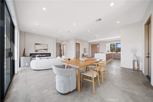 62290 Crestview Dr, Joshua Tree, CA 92252 - dining area with concrete floors, a glass covered fireplace, and recessed lighting