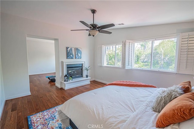 26511 Brooks Cir, Stevenson Ranch, CA 91381 - bedroom featuring wood finished floors, a glass covered fireplace, and ceiling fan