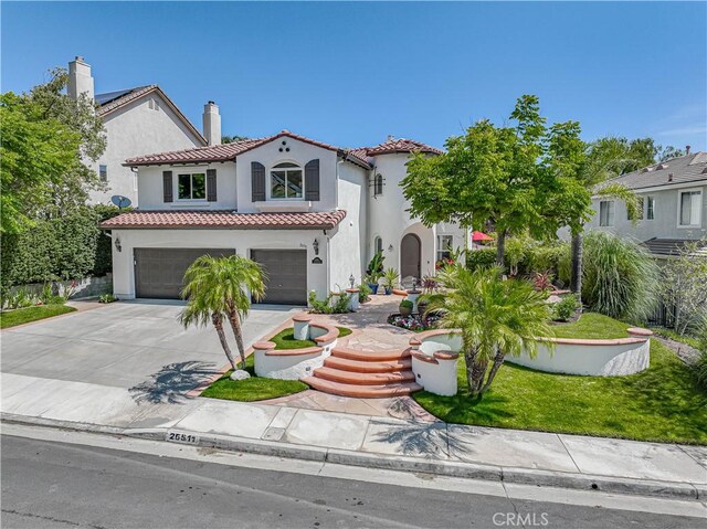 26511 Brooks Cir, Stevenson Ranch, CA 91381 - mediterranean / spanish home featuring an attached garage, driveway, a chimney, stucco siding, and a tiled roof