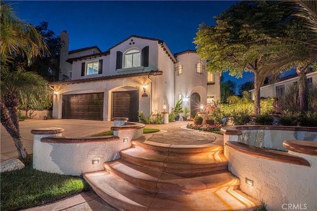 26511 Brooks Cir, Stevenson Ranch, CA 91381 - mediterranean / spanish house featuring an attached garage, stucco siding, and driveway
