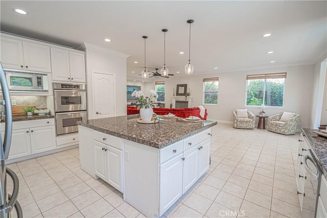 26511 Brooks Cir, Stevenson Ranch, CA 91381 - kitchen featuring stainless steel appliances, open floor plan, light tile patterned floors, recessed lighting, and crown molding