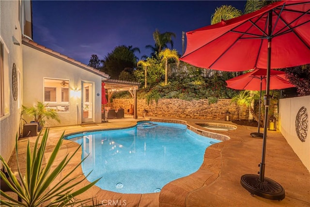 26511 Brooks Cir, Stevenson Ranch, CA 91381 - pool at twilight featuring an in-ground hot tub, a patio area, and a fenced backyard