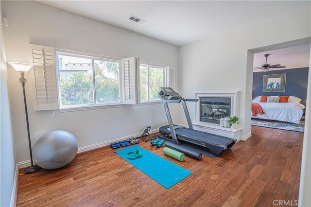 26511 Brooks Cir, Stevenson Ranch, CA 91381 - exercise room featuring wood finished floors, ceiling fan, and a glass covered fireplace