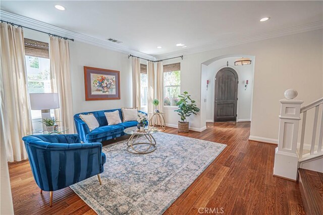26511 Brooks Cir, Stevenson Ranch, CA 91381 - living room with plenty of natural light, arched walkways, wood finished floors, ornamental molding, and recessed lighting