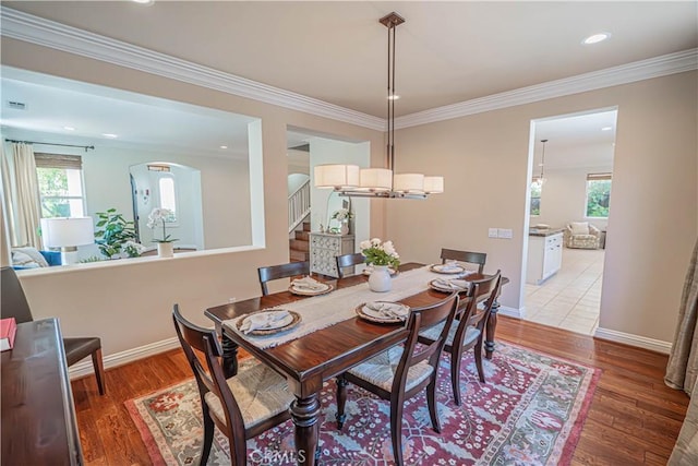 26511 Brooks Cir, Stevenson Ranch, CA 91381 - dining space featuring stairway, light wood-style flooring, ornamental molding, recessed lighting, and arched walkways