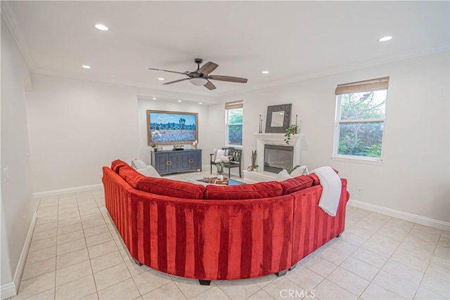 26511 Brooks Cir, Stevenson Ranch, CA 91381 - living room featuring light tile patterned floors, a glass covered fireplace, recessed lighting, ceiling fan, and crown molding