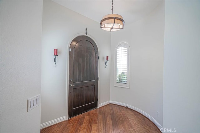 26511 Brooks Cir, Stevenson Ranch, CA 91381 - foyer with wood finished floors, a chandelier, and arched walkways
