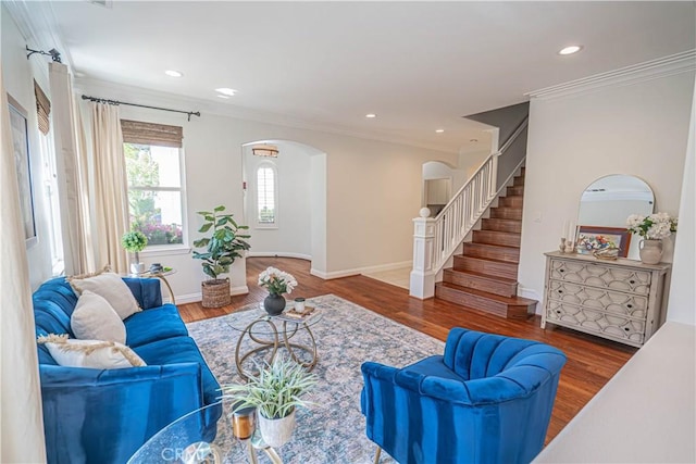 26511 Brooks Cir, Stevenson Ranch, CA 91381 - living room with arched walkways, crown molding, stairway, wood finished floors, and recessed lighting