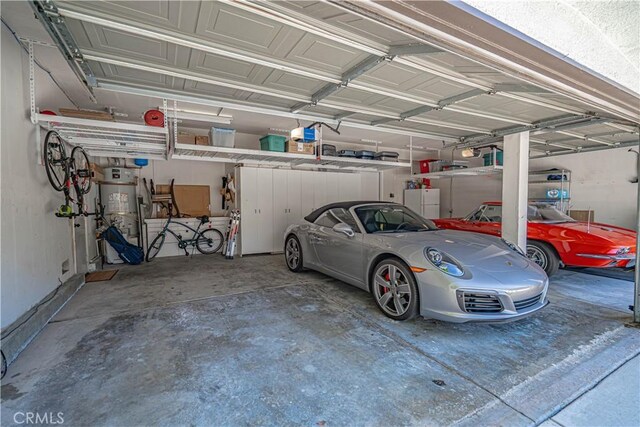26511 Brooks Cir, Stevenson Ranch, CA 91381 - garage with strapped water heater and a garage door opener