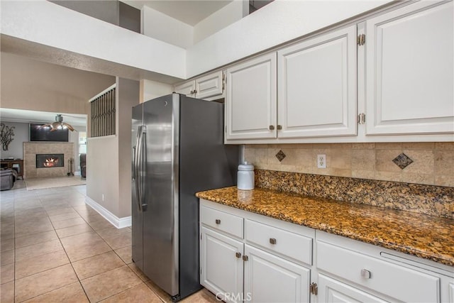 26490 Mapleridge Way, Moreno Valley, CA 92555 - kitchen featuring stainless steel refrigerator with ice dispenser, decorative backsplash, dark stone counters, light tile patterned floors, and white cabinets