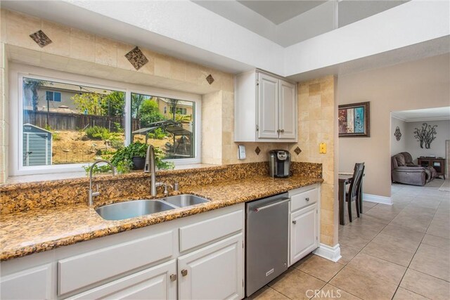 26490 Mapleridge Way, Moreno Valley, CA 92555 - kitchen featuring stainless steel dishwasher, white cabinetry, light tile patterned floors, and light stone counters