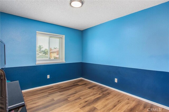 26490 Mapleridge Way, Moreno Valley, CA 92555 - spare room featuring a textured ceiling and wood finished floors