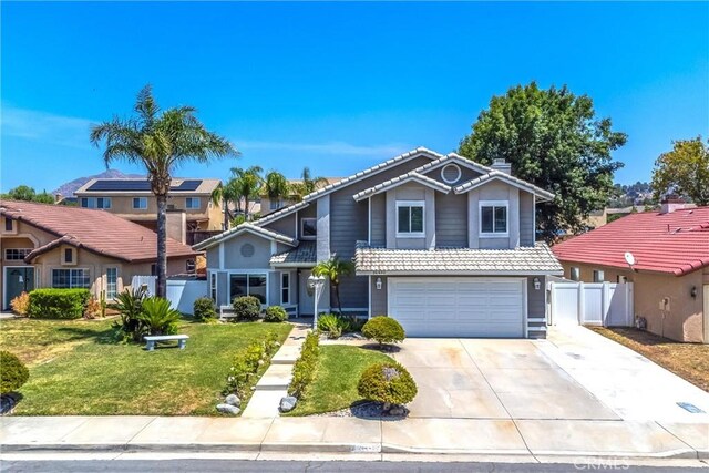 26490 Mapleridge Way, Moreno Valley, CA 92555 - traditional-style house with a garage, concrete driveway, a chimney, a tile roof, and a residential view