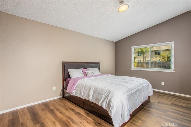 26490 Mapleridge Way, Moreno Valley, CA 92555 - bedroom featuring vaulted ceiling, wood finished floors, and a textured ceiling