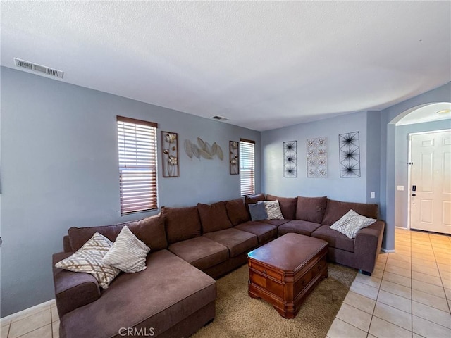 2753 Hornbeam Rd, Palmdale, CA 93551 - living area with light tile patterned floors, arched walkways, and a textured ceiling