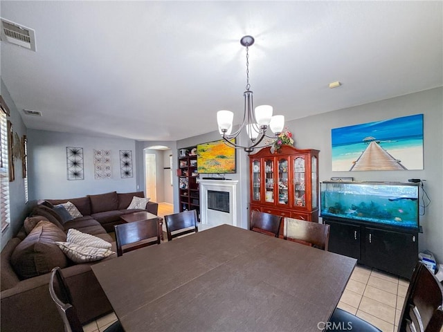 2753 Hornbeam Rd, Palmdale, CA 93551 - dining space with arched walkways, light tile patterned floors, a chandelier, and built in features