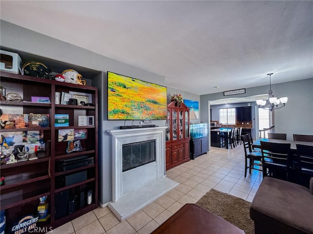 2753 Hornbeam Rd, Palmdale, CA 93551 - living room with a chandelier, light tile patterned floors, and a glass covered fireplace
