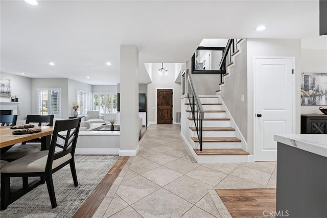 11533 Poppyglen Ct, Moorpark, CA 93021 - entrance foyer with stairway, a fireplace, light tile patterned flooring, and recessed lighting