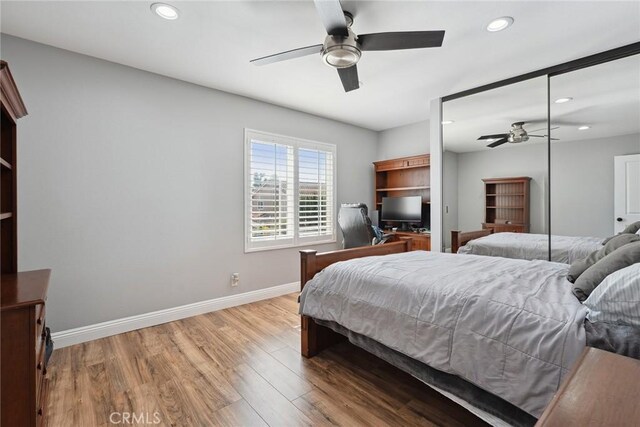 11533 Poppyglen Ct, Moorpark, CA 93021 - bedroom featuring recessed lighting, light wood-type flooring, a desk, ceiling fan, and a closet