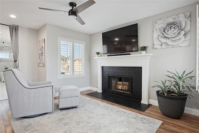 11533 Poppyglen Ct, Moorpark, CA 93021 - living room with wood finished floors, a ceiling fan, a tiled fireplace, and recessed lighting