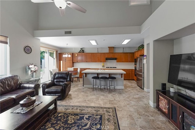 2175 Lester Ave, Clovis, CA 93619 - living room with ceiling fan, a towering ceiling, and a chandelier