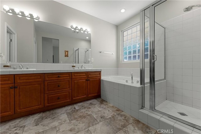 2175 Lester Ave, Clovis, CA 93619 - bathroom featuring a shower stall, a bath, double vanity, and recessed lighting