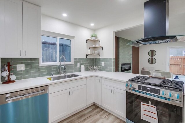 6548 Bantam Lake Cir, San Diego, CA 92119 - kitchen featuring appliances with stainless steel finishes, island range hood, light countertops, white cabinets, and recessed lighting