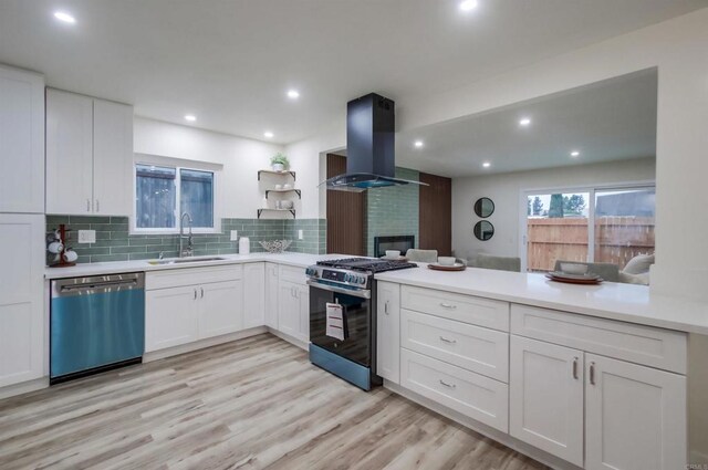 6548 Bantam Lake Cir, San Diego, CA 92119 - kitchen with appliances with stainless steel finishes, island exhaust hood, a peninsula, white cabinets, and recessed lighting
