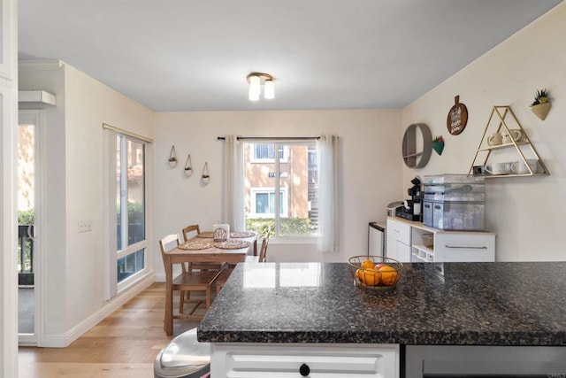 17119 W Bernardo Dr Unit 105, San Diego, CA 92127 - kitchen featuring light wood-type flooring, white cabinetry, dark stone counters, and beverage cooler