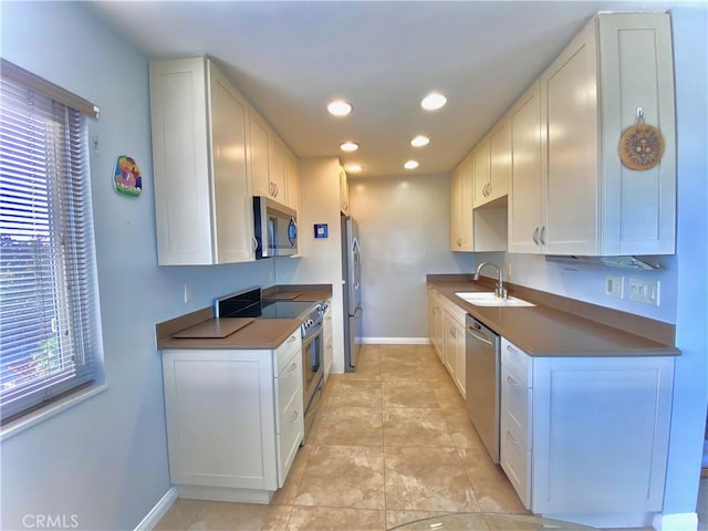 3707 E Livingston Dr Unit 403, Long Beach, CA 90803 - kitchen with stainless steel appliances, dark countertops, recessed lighting, and white cabinetry