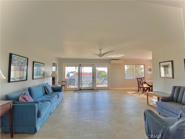3707 E Livingston Dr Unit 403, Long Beach, CA 90803 - living area with a wall mounted air conditioner, light tile patterned flooring, and a ceiling fan