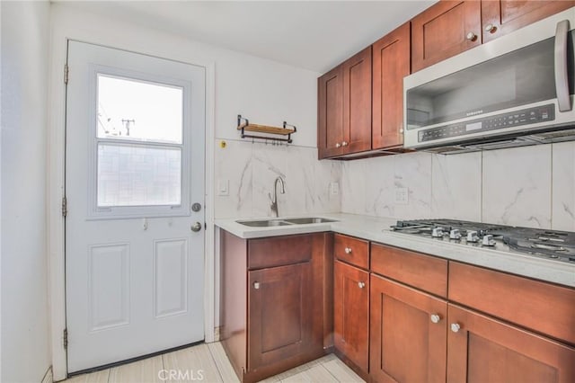 12818 Ramsey Dr, La Mirada, CA 90638 - kitchen with stainless steel appliances, light countertops, tasteful backsplash, and brown cabinetry