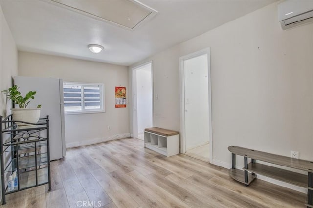 12818 Ramsey Dr, La Mirada, CA 90638 - spare room with a wall mounted air conditioner, attic access, and wood finished floors