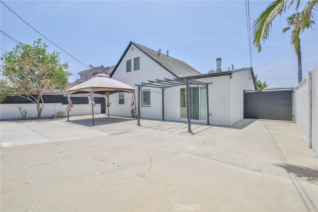 12818 Ramsey Dr, La Mirada, CA 90638 - back of property featuring a pergola, a patio area, a gazebo, and stucco siding