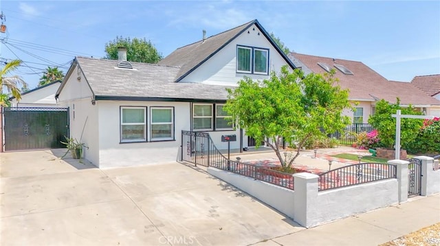 12818 Ramsey Dr, La Mirada, CA 90638 - view of front of property featuring a fenced front yard, stucco siding, a shingled roof, and a gate