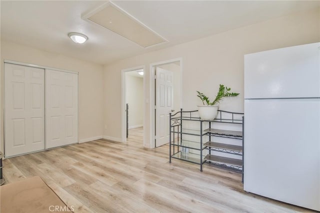 12818 Ramsey Dr, La Mirada, CA 90638 - bedroom featuring freestanding refrigerator, attic access, light wood-style floors, and a closet