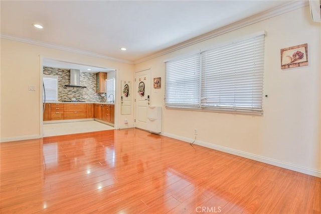 12818 Ramsey Dr, La Mirada, CA 90638 - unfurnished living room featuring light wood-type flooring, crown molding, and recessed lighting