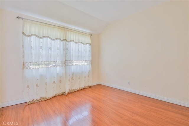 12818 Ramsey Dr, La Mirada, CA 90638 - empty room with wood finished floors and lofted ceiling