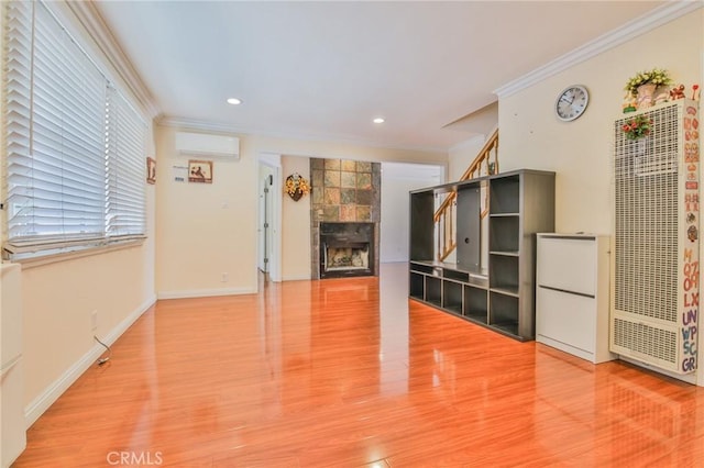 12818 Ramsey Dr, La Mirada, CA 90638 - unfurnished living room with a heating unit, an AC wall unit, ornamental molding, a tile fireplace, and wood finished floors