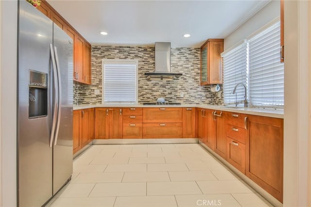 12818 Ramsey Dr, La Mirada, CA 90638 - kitchen featuring stainless steel fridge with ice dispenser, wall chimney range hood, light countertops, brown cabinets, and recessed lighting